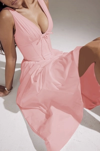 Close-up detail of the V-neckline and waist tie on this elegant pink summer maxi dress