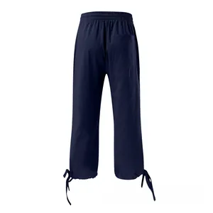 Back view of deep blue linen wide-leg pants showing elastic waist and drawstring hem