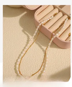 Detail of elegant double-layered necklace featuring fresh water pearls and gold beads