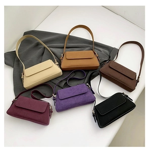 Detailed overhead view showing all six colors of the suede baguette shoulder bags