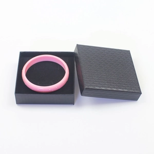 Pink polka dot bangle displayed in a premium black textured jewelry gift box