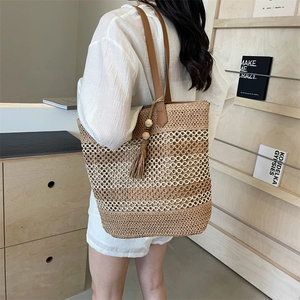 Large woven checkered beach bag with brown PU leather straps and a stylish tassel