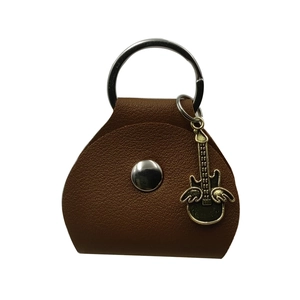 Brown leather guitar pick case with silver ring clasp and winged guitar pendant detail