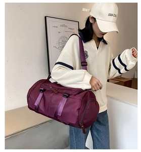 Detail of purple waterproof nylon cylinder travel bag with zippers and buckle straps