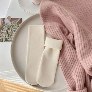 Detail view of ivory snow socks featuring ribbed knit texture and soft fleece lining