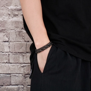 Detail of double-layer matte black stainless steel chain bracelet on a male wrist