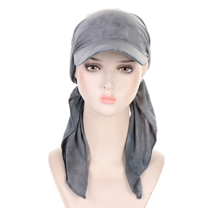 Detail of dark grey tie-dye turban hat with curved brim on a professional mannequin