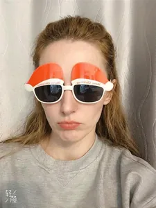 Selfie shot of festive Christmas hat party glasses with Merry Christmas text on the frame