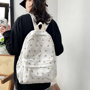 Floral canvas backpack with pink small flower pattern on white background for students