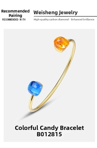 Detail of candy-colored gold open bangle with square orange and blue gemstones