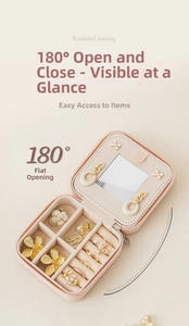 Pink portable travel jewelry box showing 180-degree flat opening and interior mirror