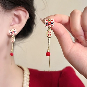 Detail of Chinese New Year lion dance earrings with tassel and lucky character charm