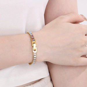 Macro detail of gold-plated bracelet featuring colorful emerald-cut cubic zirconia