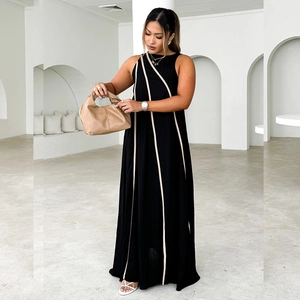 Elegant sleeveless black and beige striped maxi dress in a minimalist modern setting
