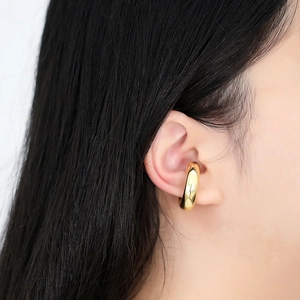 Polished 18k gold plated round ear cuff shown on model for a minimalist fashion look