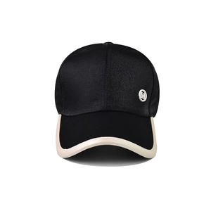Minimalist black and white patchwork baseball cap with satin crown and M logo badge