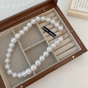 Baroque style necklace with large round white pearls in a vintage wooden jewelry box