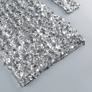 Detailed close-up of high-density silver sequins on elegant long sleeve party dress