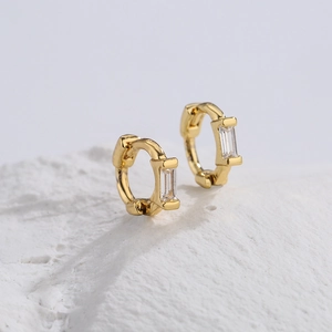 Pair of 18K gold plated cross hoop earrings with rectangular zircon on white rock base