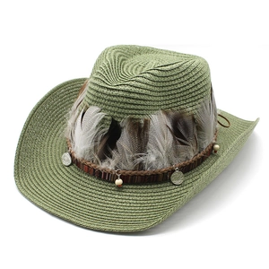 Green woven straw cowboy hat with ethnic feathers and decorative silver pendants