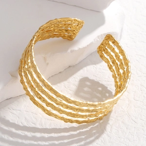 Irregular textured gold stainless steel open bangle with layered minimalist design