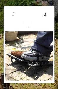 Detail of vintage cast iron shoe scraper with stiff bristles on a stone garden path