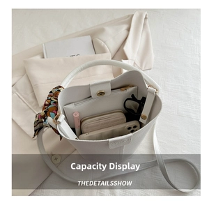 Interior view of white bucket bag showing large capacity for essentials and floral scarf