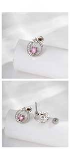 Detail of silver cartilage earrings with pink star gem and screw back closure