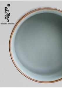 Detailed macro view of smooth celadon glaze interior with rustic brown ceramic rim