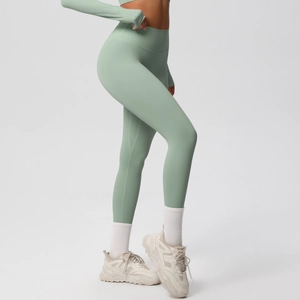 Close-up of sage green high-waist seamless leggings and long sleeve cropped gym top