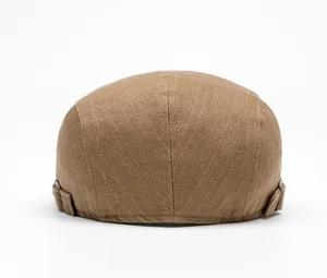 Detail view of khaki newsboy cap back with adjustable metal buckles and fine stitching
