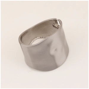 Macro shot of silver wide-band metal bracelet with brushed matte finish and irregular design