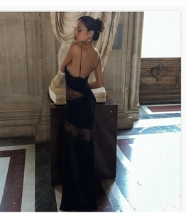 Detail of elegant black backless lace dress showing sheer panels and slim fit design