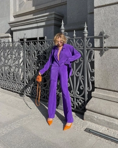 Women's purple pleated two-piece set featuring long-sleeve top and loose wide-leg pants