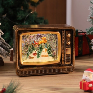 Detail of vintage TV Christmas snow globe with Santa sleigh and festive scenery
