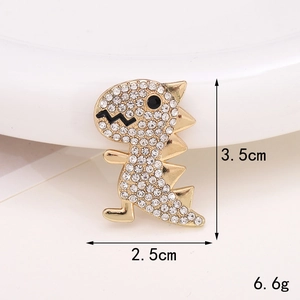 Detailed view of a gold dinosaur charm with white rhinestones measuring 3.5cm by 2.5cm