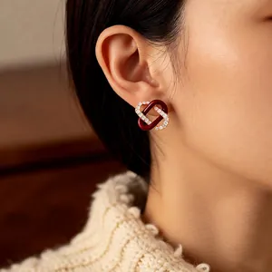 Elegant gold plated interlocking circle earrings with burgundy resin and white cubic zirconia