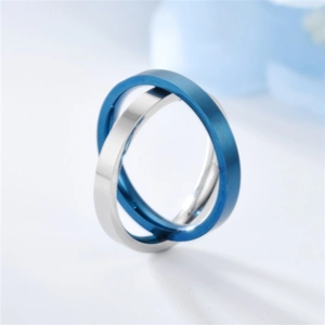Macro detail of interlocked blue and silver titanium steel spinning anxiety rings