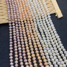 Detail of natural freshwater pearls in white pink and purple on a woven bamboo mat