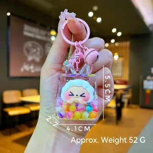 Detail of acrylic liquid sheep keychain in bag shape with pink bell and size markings