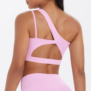 Detailed back view of pink yoga sports bra with asymmetrical straps and hollow-out design