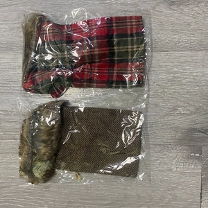 Close-up of red plaid and brown herringbone Christmas wine bottle covers with fur trim