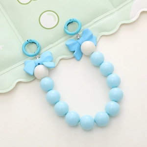 Detail of candy blue acrylic phone charm with cute bows and round resin beads