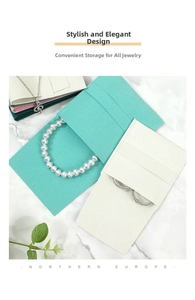 Close-up of microfiber jewelry pouches in various colors on marble background