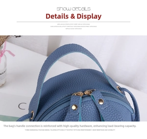 Close-up of blue lychee grain leather bag with reinforced hardware and dual zippers