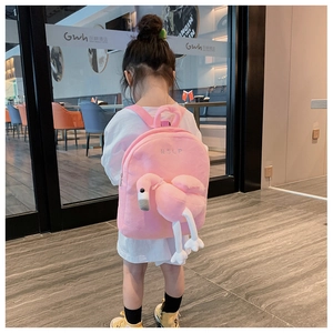 Close-up of pink plush children's backpack featuring a 3D flamingo and HSLP embroidery