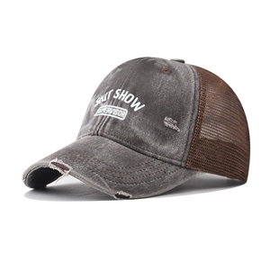 Detailed side view of distressed trucker cap with mesh back and embroidered slogan