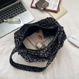 Top view of spacious grey leopard print plush tote bag with daily essentials inside
