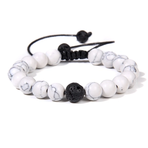 Detailed macro view of white marble beads and black lava stone on adjustable cord