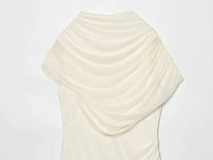 Detailed close-up of cream white pleated mesh fabric showing delicate layered texture and sheer finish